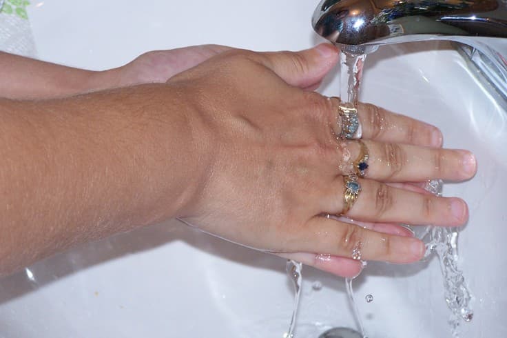 Hands being washed under running water