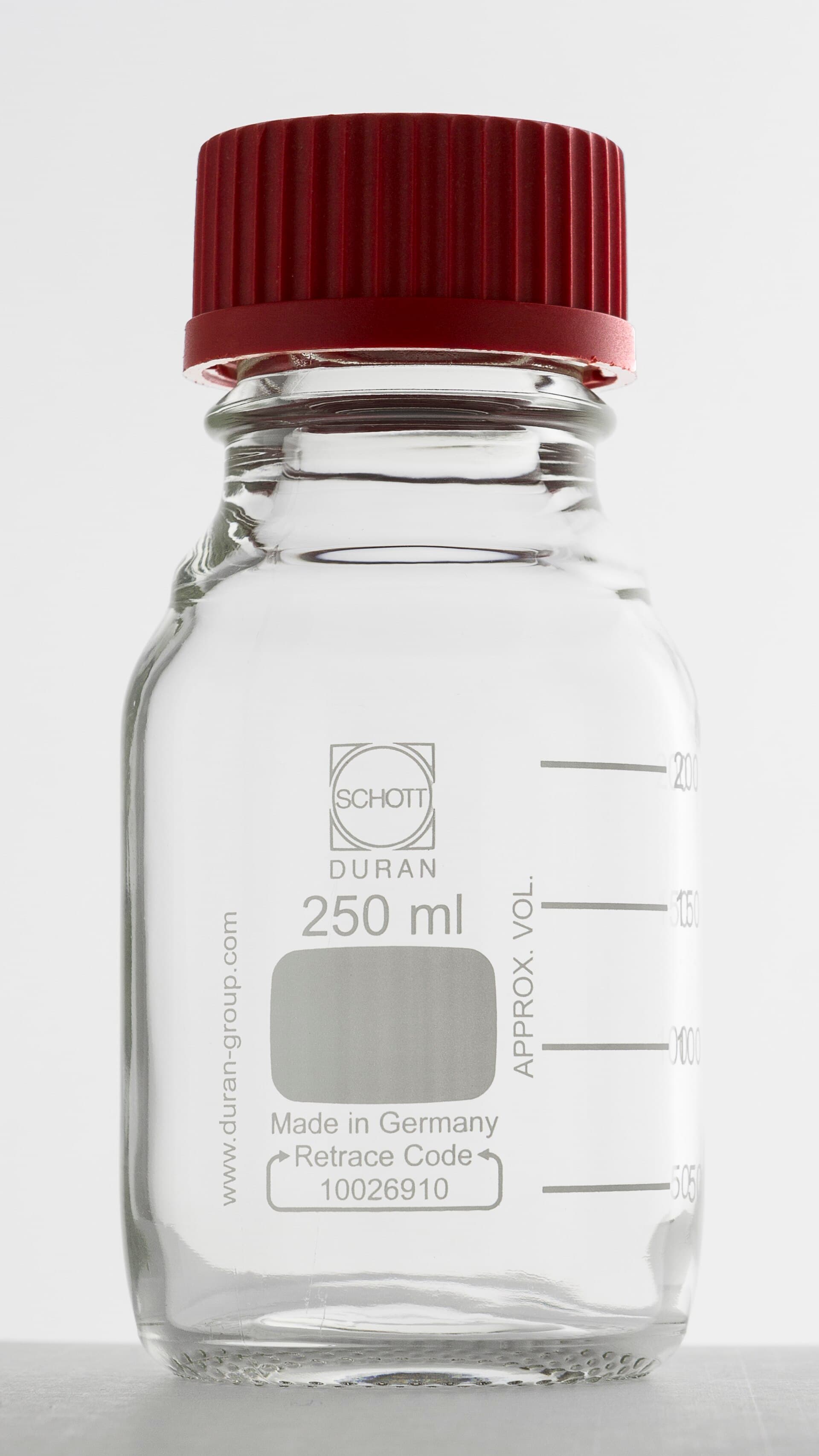 A clear laboratory glass bottle
